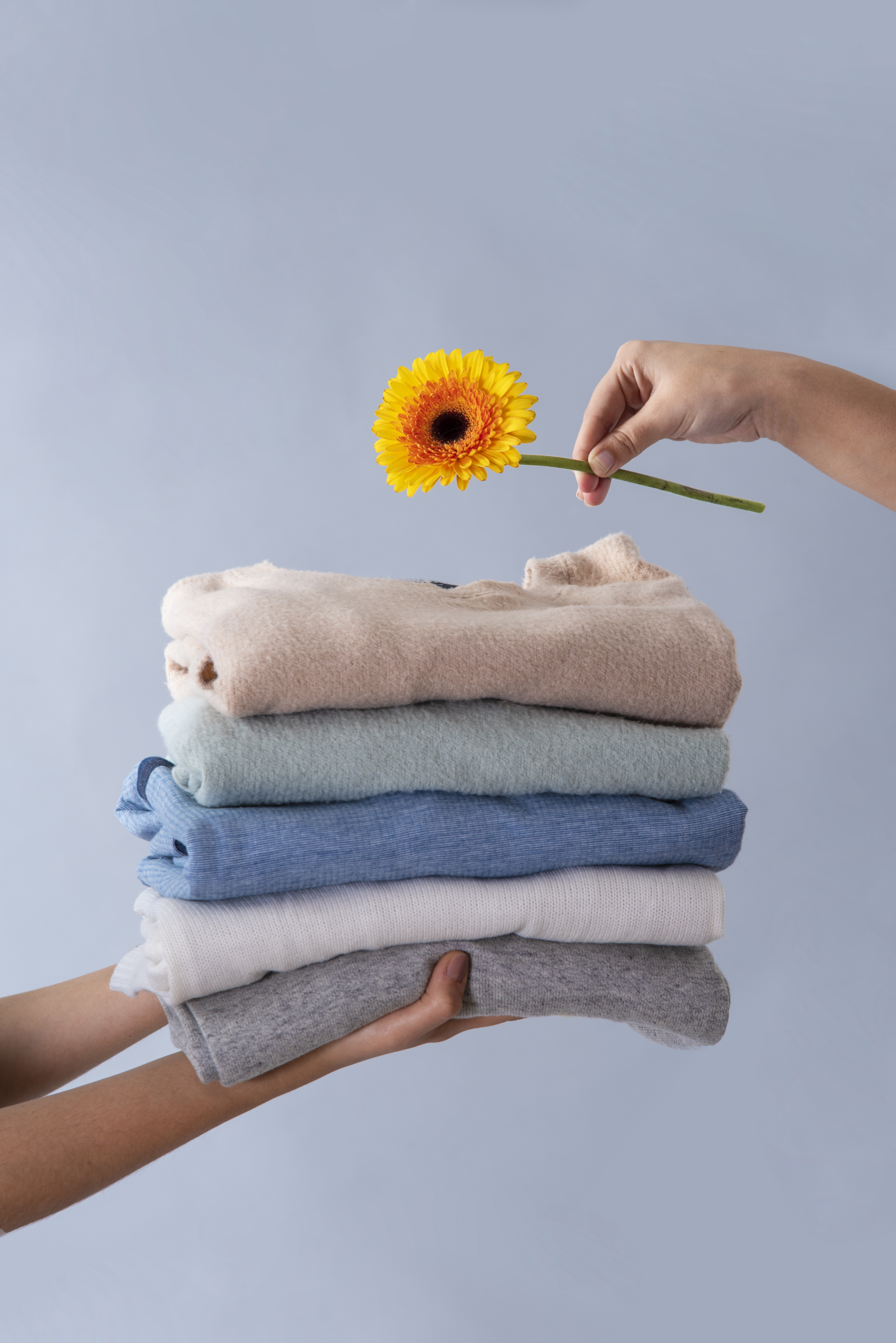 side-view-people-holding-clothes-flower